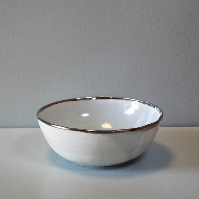 Handmade porcelain bowl with silver