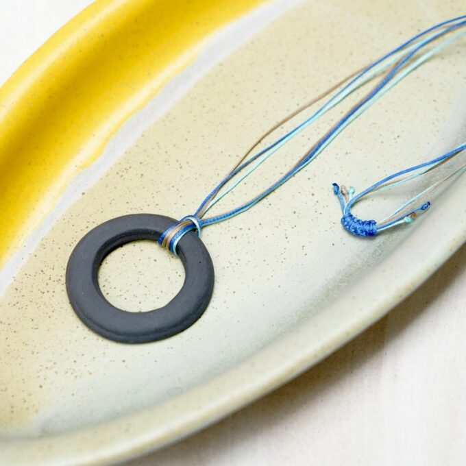 waxthread necklace with matte black circular ceramic ring