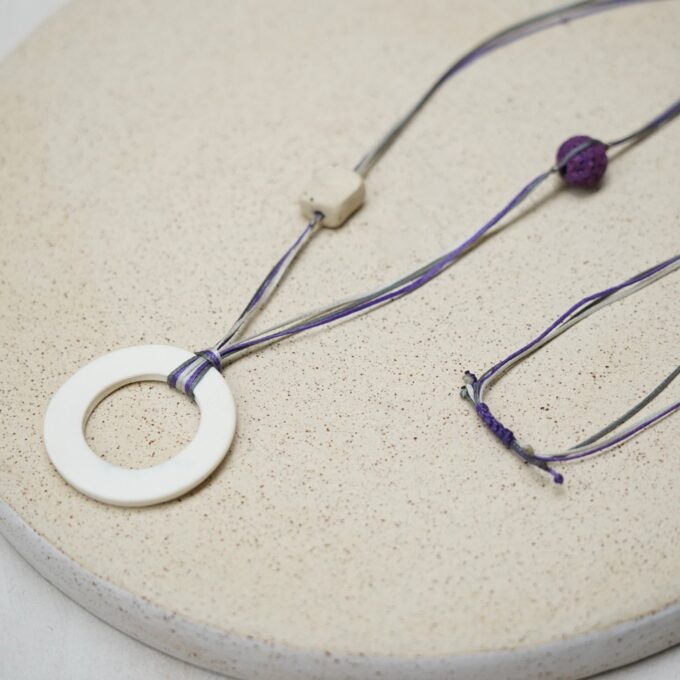 off-white ceramic ring necklace with orange waxthread
