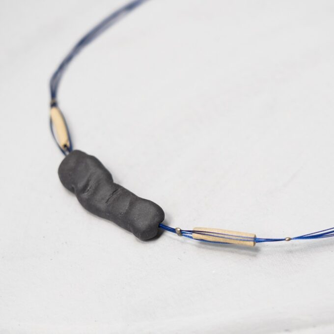 black ceramic sculpted necklace on blue wire