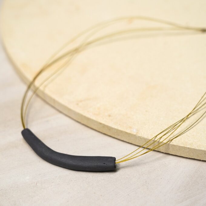 handmade curved ceramic necklace on gold wire