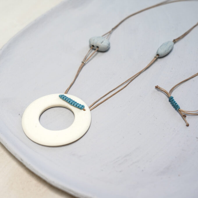 off-white ceramic ring necklace with turquoise accent knot