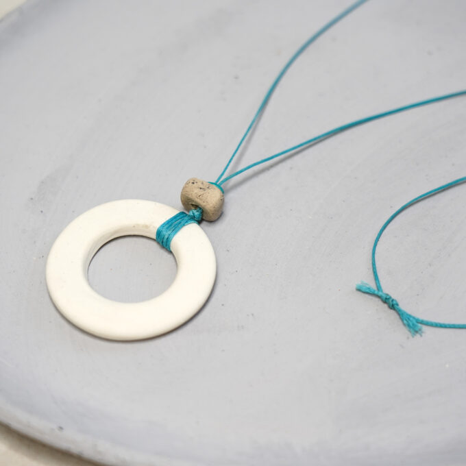 off-white ceramic ring necklace with turquoise waxthread