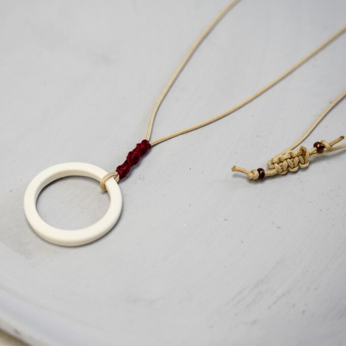 off-white ceramic ring necklace with waxthread and burgundy wrap