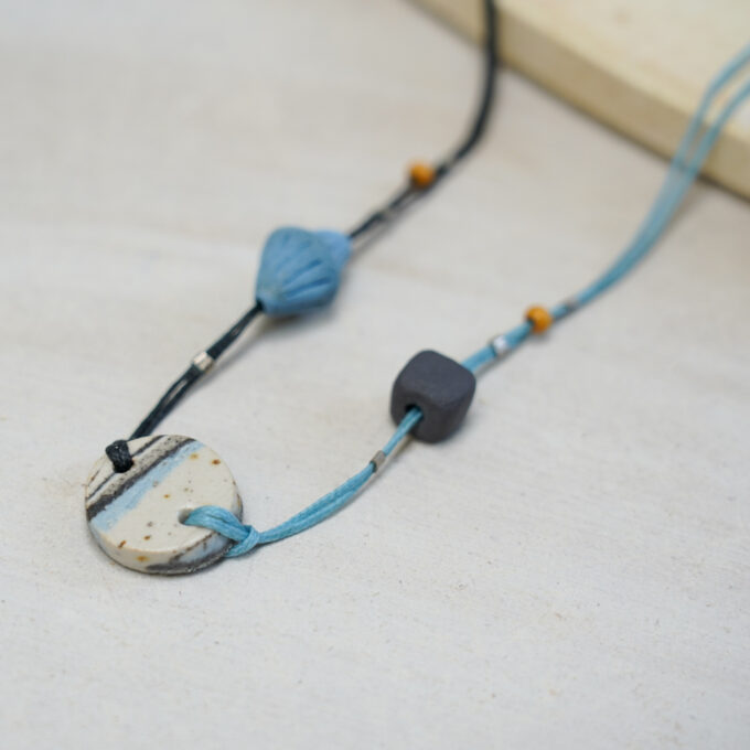 striped ceramic disc necklace with dual-tone waxthread