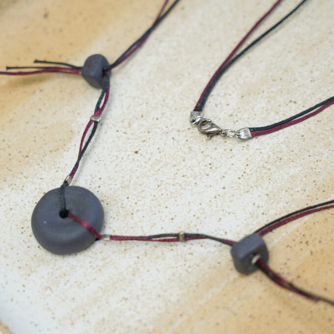 rounded perforated grey ceramic disc necklace with waxthread