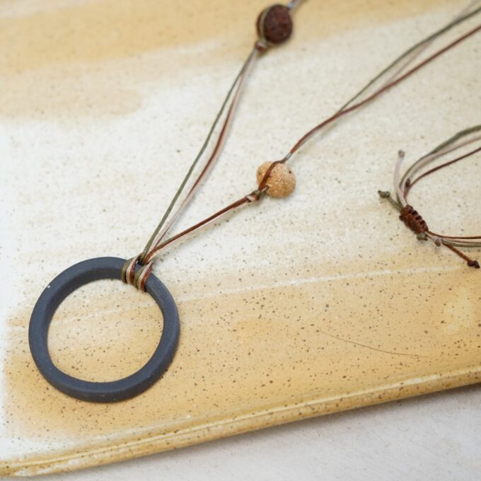 handmade waxthread necklace with circular ceramic ring
