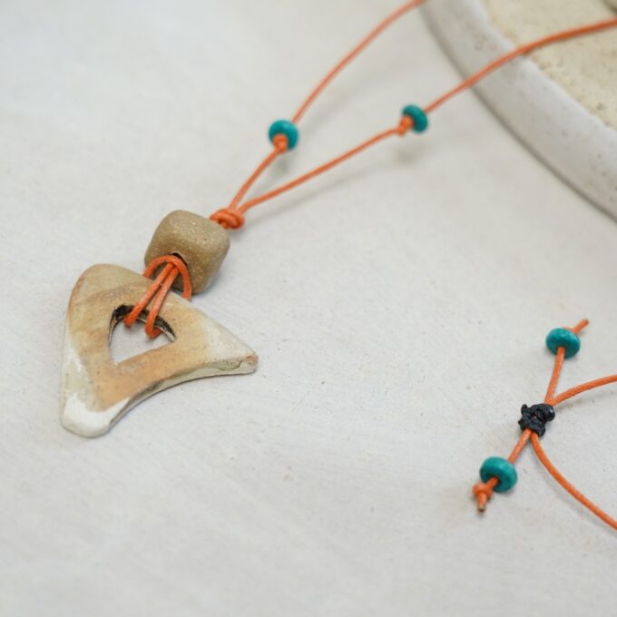 orange waxthread necklace with open ceramic triangle and turquoise beads