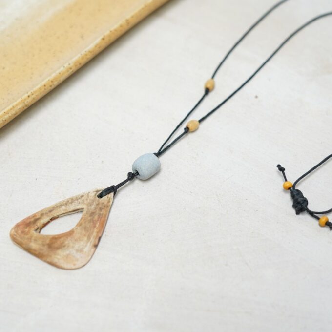 waxthread necklace with open earth-toned ceramic triangle