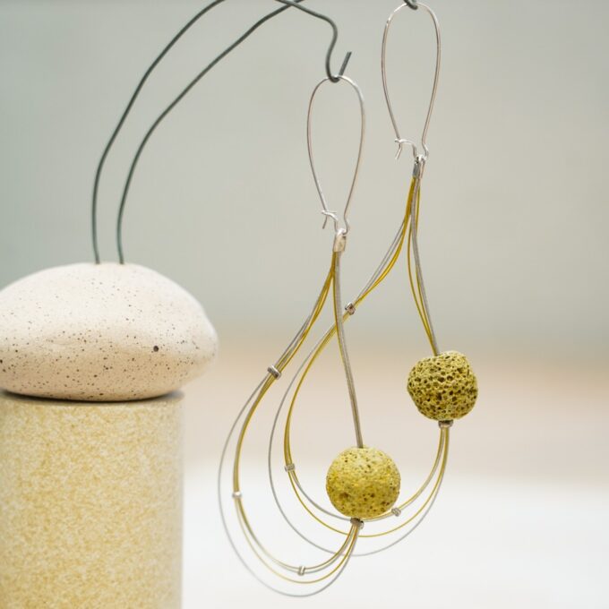 layered wire earrings with textured ceramic beads