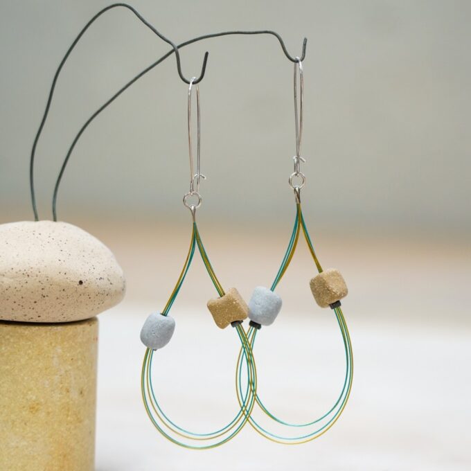 wire earrings with triple ceramic beads and open loop design