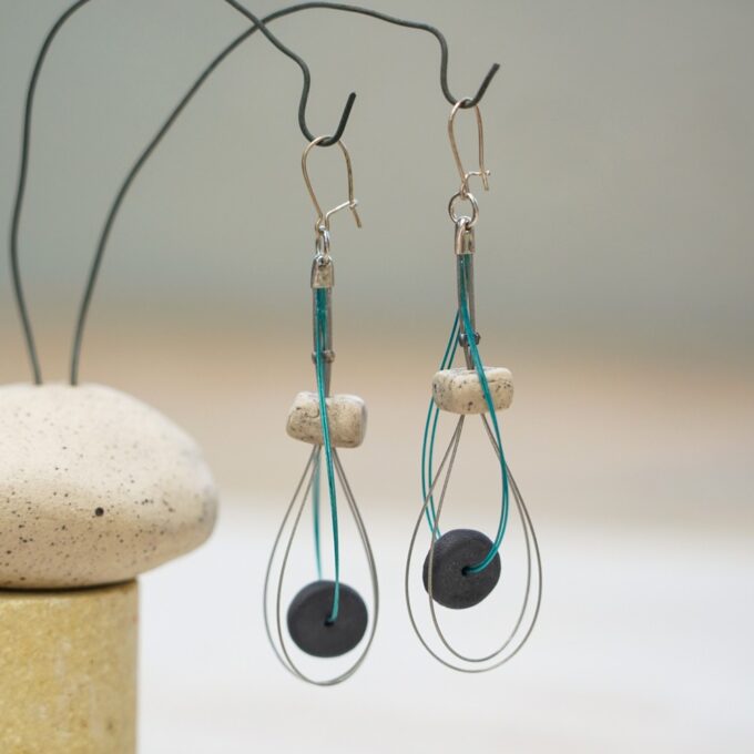 wire earrings with dark ceramic discs and layered loops
