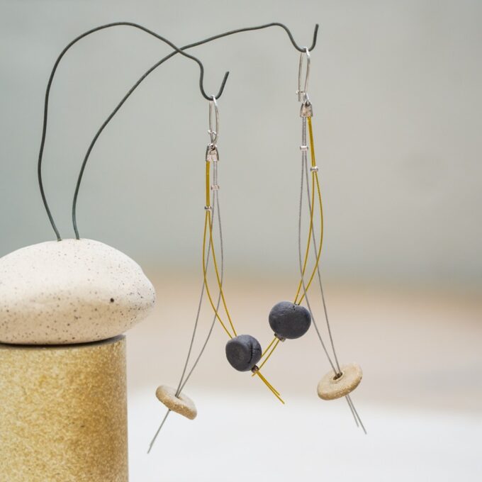 wire earrings with ceramic discs and curved linear elements