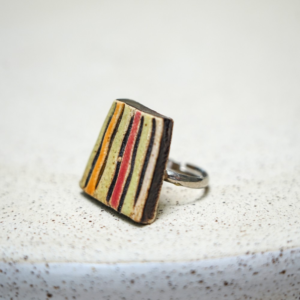 ceramic ring with vertical stripe glaze pattern