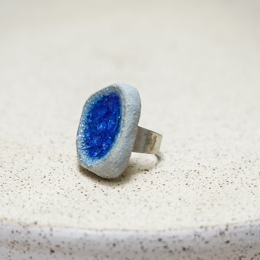 handmade ceramic ring with deep blue glass centre
