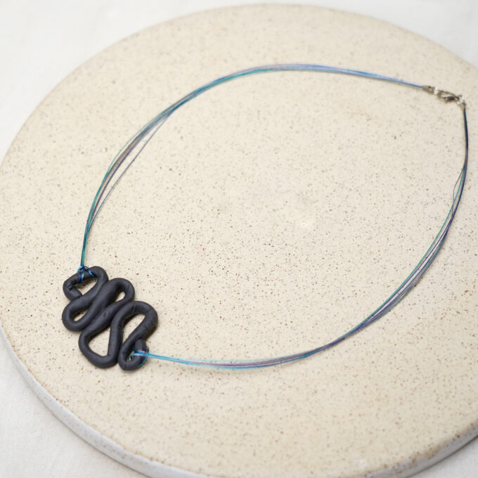 jewelry wire necklace with sculptural dark element