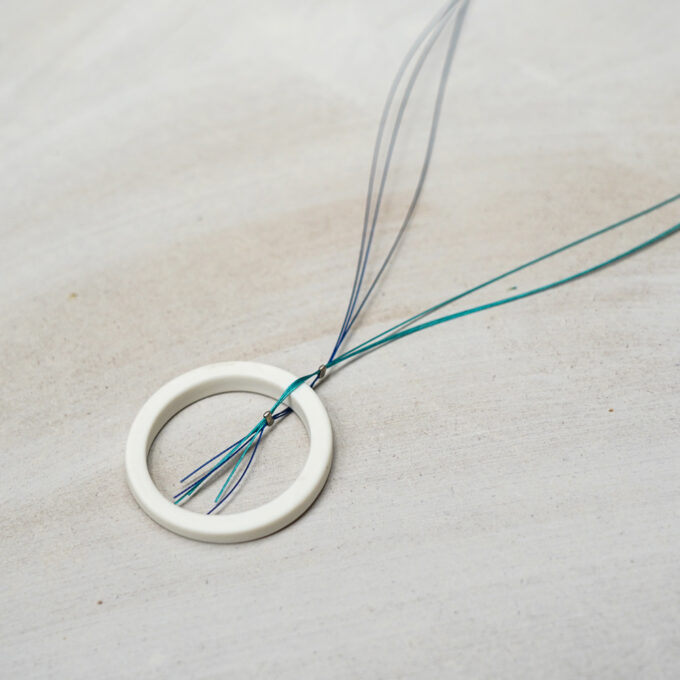vory ceramic open circle wire necklace on light surface