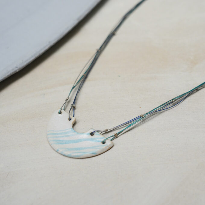 crescent ceramic wire necklace with blue pattern