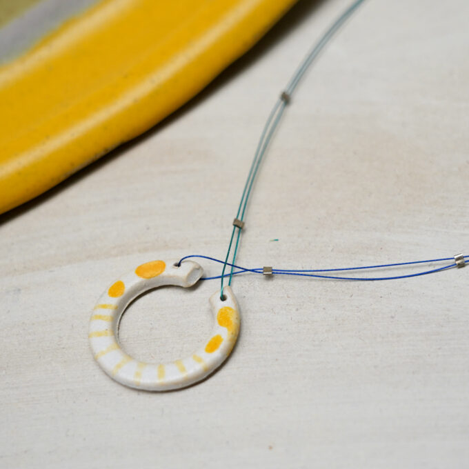 open circle ceramic wire necklace with yellow dots