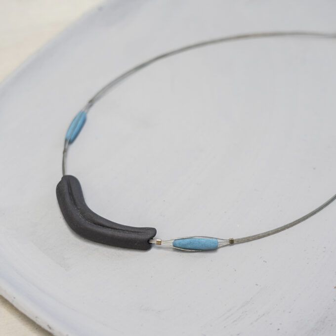 curved matte black ceramic wire necklace with blue accent