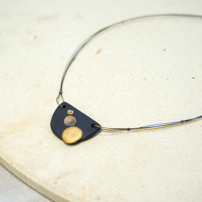 black ceramic shield wire necklace with gold dots